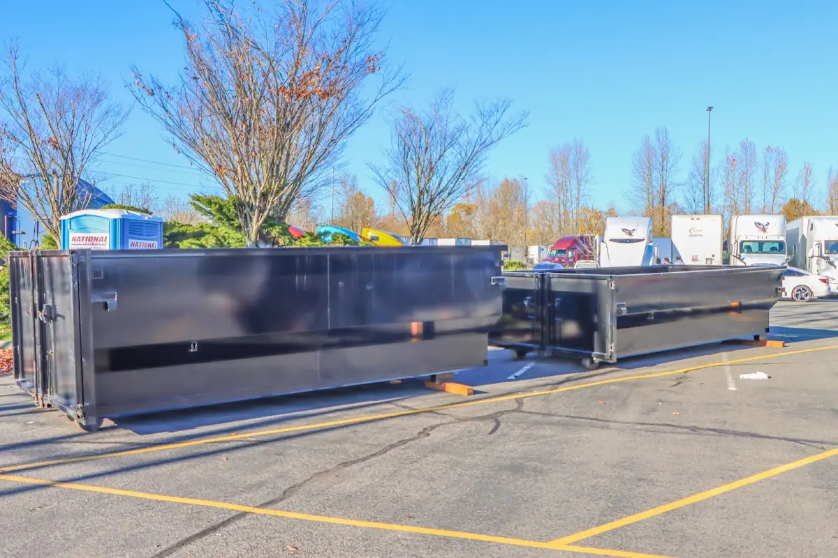 Professional dumpster rental service with roll-off container on residential driveway in Glassboro